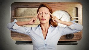 A woman tries to think with her mental radio behind her